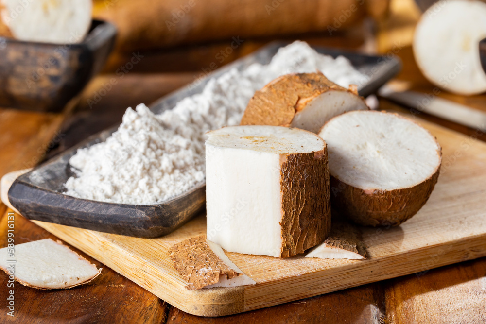 pile of cassava, cassava and cassava flour on a background of rustic wood (Manihot esculenta) pile of cassava, cassava and cassava flour on a background of rustic wood (Manihot esculenta)