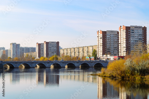 Panorama of the city in autumn. River and bridge and residential high-rise buildings © Maksim