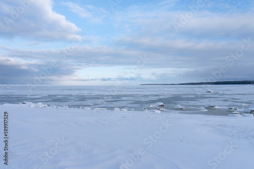 the seashore in winter. the sea is under ice and snow © Наталия Бушкевич