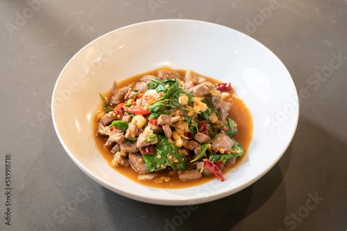 Flatlay, Topview of Stir-Fried Beef Basil is a Famous Thai Food Style. It is ready to serves and eats from white bowl. It is set in studio light. Clipping Path.