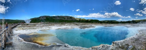 Sapphire pool, Yellowstone national park, Wyoming. Sapphire Pool has a solid sinter rim level with the ground surface. The edges have shallow sinter shelves that contain yellow and orange thermophiles