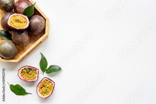 Wooden bowl of whole and half of passion fruit - marakuya
