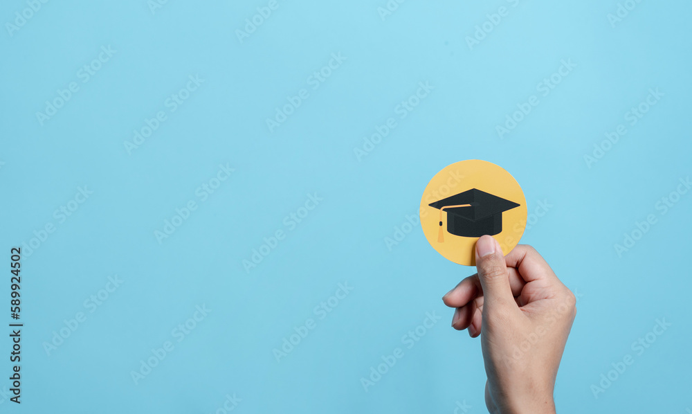 Hand holding education cap paper cut, leading to success goal. Taking strategic steps towards graduation. Career path and first for business, Graduation achievement goals concept. Graduation cap.