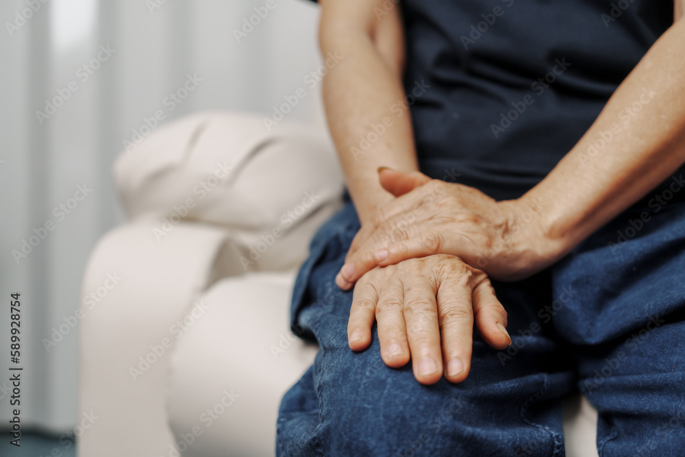 Close up hands of asian senior elderly woman with parkinson's disease