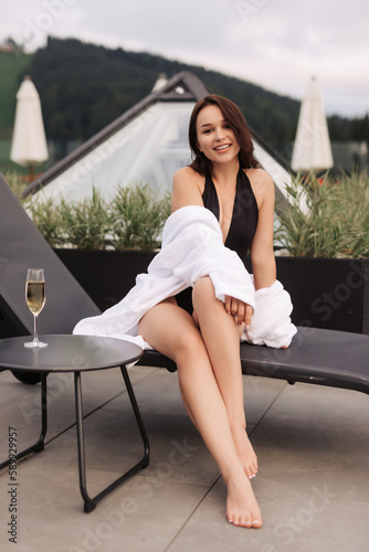 Summer holiday girl enjoying vacation with champagne.