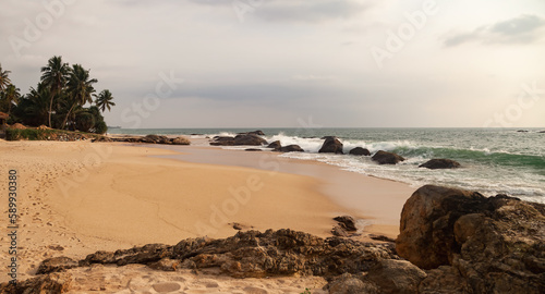Tropical natural ocean coastline landscape with stone on sandy beach  amazing tropic scenery. Fantastic image sea for vacation design. Concept of summer vacation and travel holiday. Copy ad text space