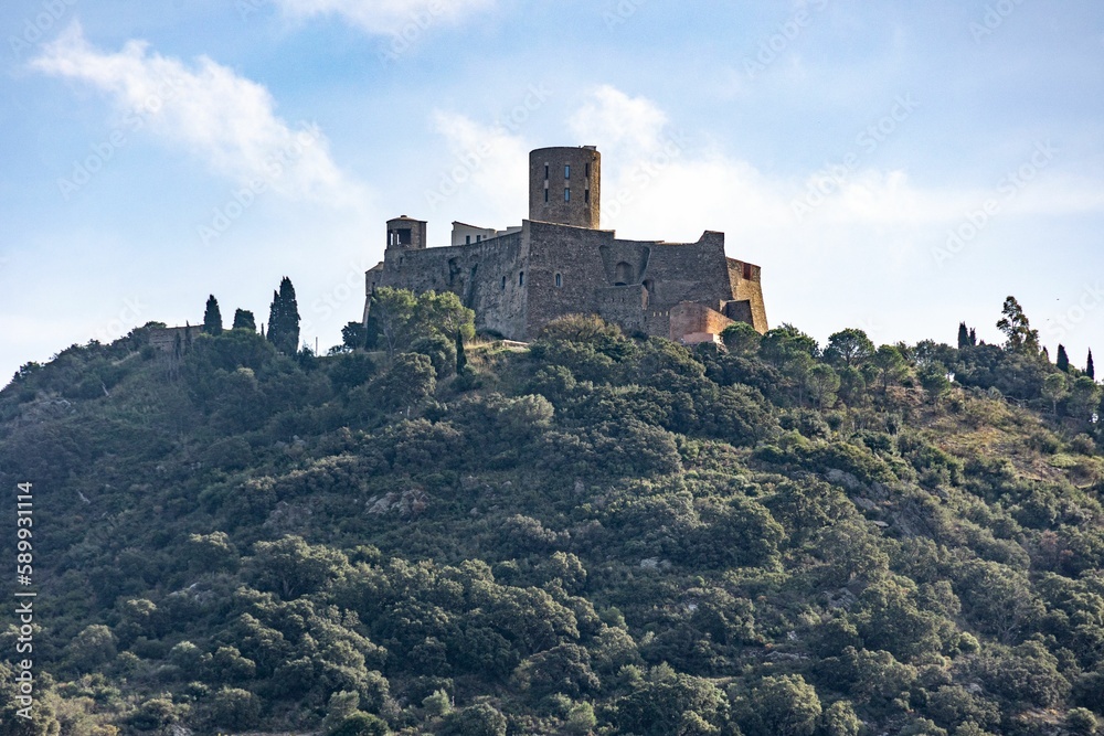 Medieval castle on a forested hilltop in Collioure, France