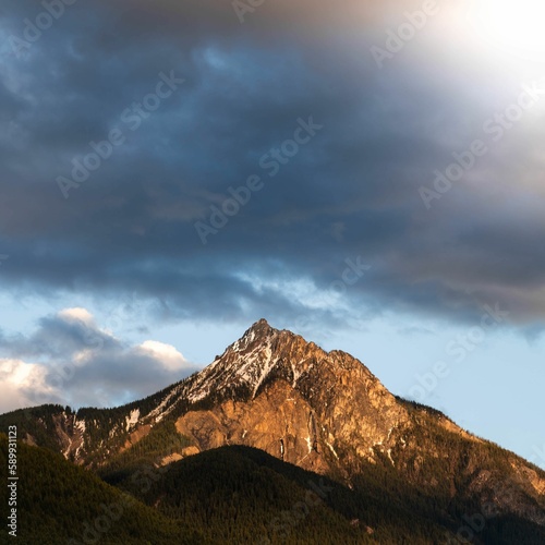 Beautiful view of a mountain with a cloudy sky background © Unknown Unknown6620/Wirestock Creators