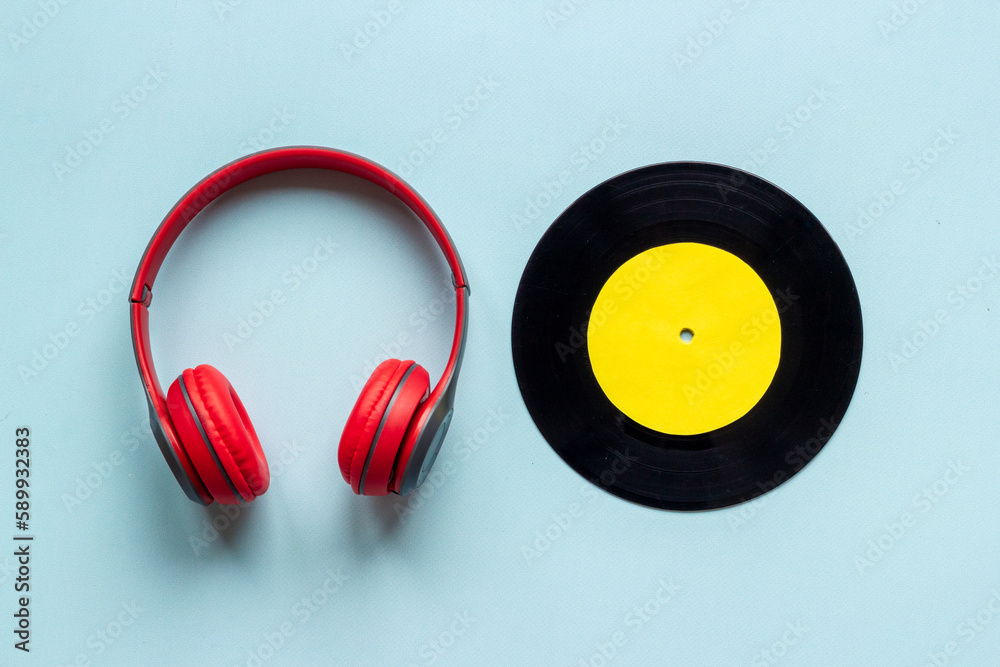 Retro style vinyl records with headphones top view. Listen to the music concept Retro style vinyl records with headphones top view. Listen to the music concept