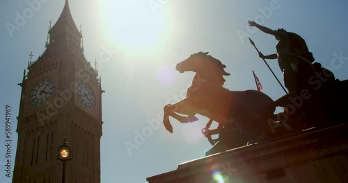 Big Ben, Houses of Parliament and Union Jack Flag flying over Boadicea or Boudica statue on Westminster Bridge, London, England
