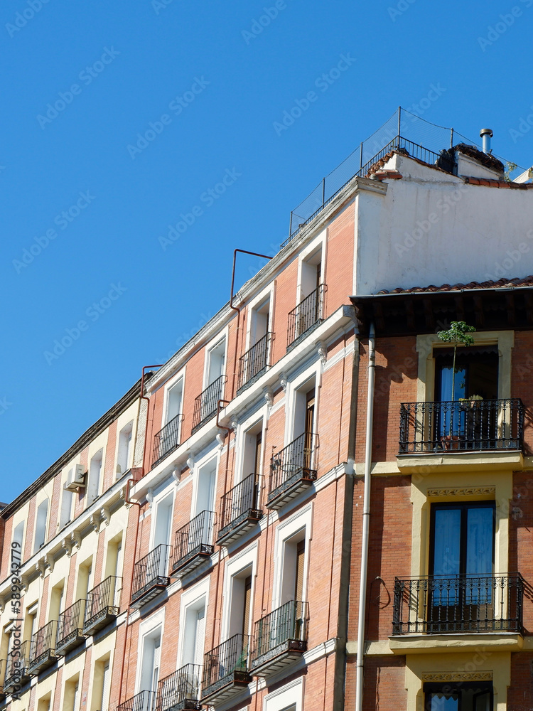 Obraz premium Classy elegant corner of the colourful building downtown Madrid, Spain. Vertical photo with copy space