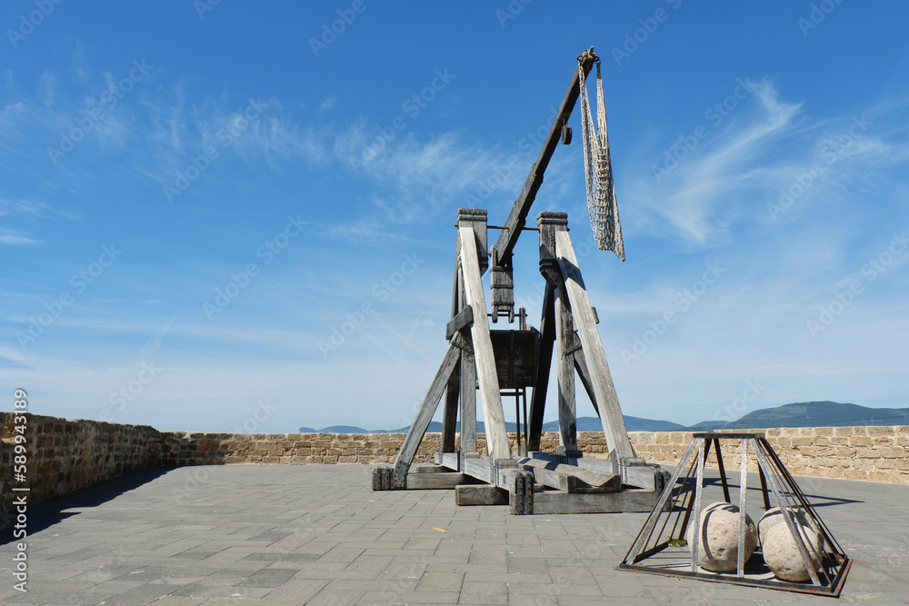 Medieval stone catapult structure on the defence wall near seaside in the historical city of Alghero, Sardinia island, Italy Medieval stone catapult structure on the defence wall near seaside in the historical city of Alghero, Sardinia island, Italy