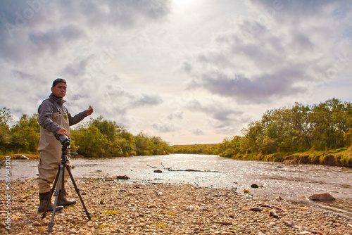 Photos Asian male in waders in Katmai River, Alaska