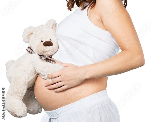 Pregnant young woman with teddy bear on background
