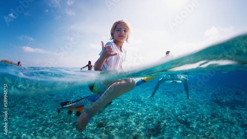 Photography Boy surfs with his father