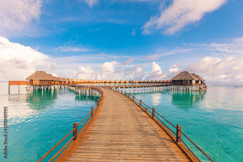 Amazing tranquil travel Maldives island, luxury over water villas pier resort. Beautiful sunny sky sea bay lagoon beach background. Summer vacation holiday. Paradise shore exotic  pristine landscape