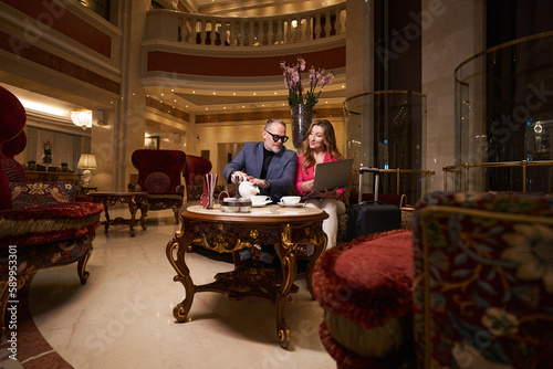 Traveling couple is resting from road in cozy seating area