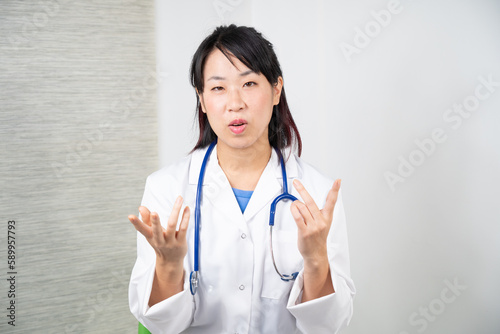 Asian female doctor during a consultation.