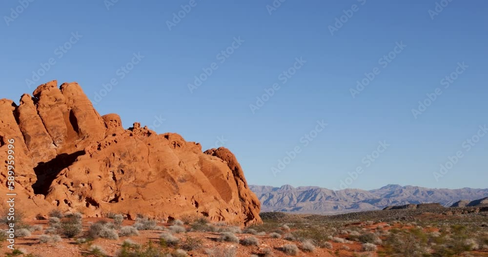 Drive Plate-Passing unique orange rock formation in the Mojave Desert in the Valley of Fire State Park of Southern Nevada. This massive formation shows erosion in the red/orange Aztec Sandstone. Drive Plate-Passing unique orange rock formation in the Mojave Desert in the Valley of Fire State Park of Southern Nevada. This massive formation shows erosion in the red/orange Aztec Sandstone.