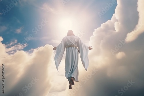 The resurrected Jesus Christ ascending to heaven above the bright light sky and clouds and God, Heaven, and Second Coming concept photo