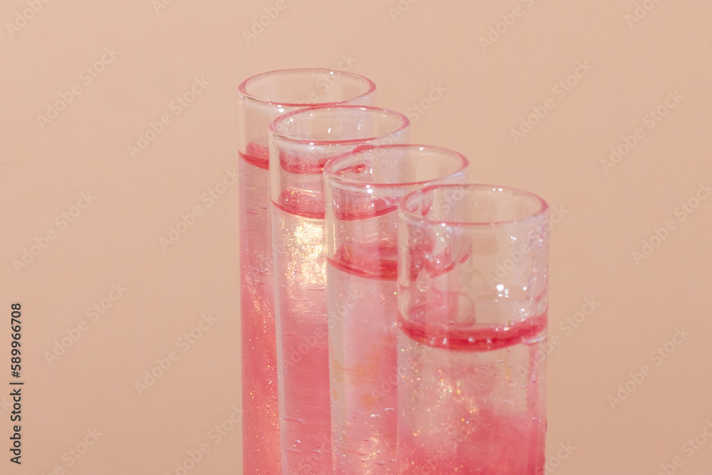 test tube with liquid rose gold. Glitter, varnish, liquid. Sequins. Laboratory research of cosmetics and liquids. The current rose gold. test tube with liquid rose gold. Glitter, varnish, liquid. Sequins. Laboratory research of cosmetics and liquids. The current rose gold.