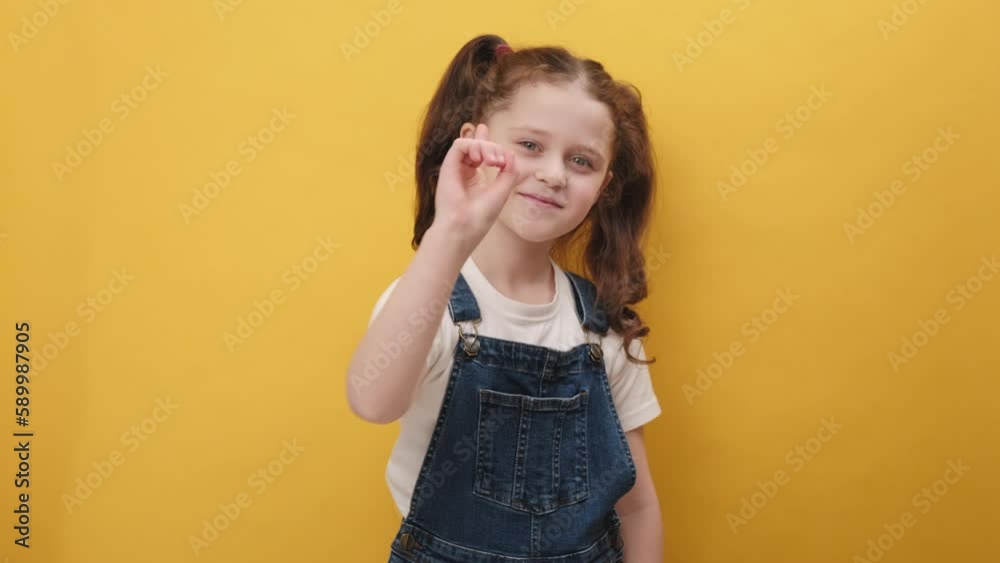 Hey you. Portrait of preteen girl kid smiling excitedly and pointing finger to camera, choosing lucky winner, indicating to awesome best you, posing isolated on yellow color background wall in studio Hey you. Portrait of preteen girl kid smiling excitedly and pointing finger to camera, choosing lucky winner, indicating to awesome best you, posing isolated on yellow color background wall in studio