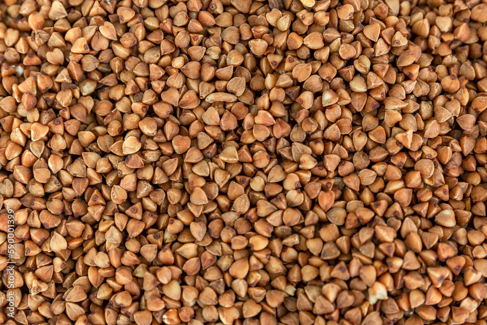 Brown buckwheat groats. Health and natural products. Close-up. Background. Space for text. Brown buckwheat groats. Health and natural products. Close-up. Background. Space for text.