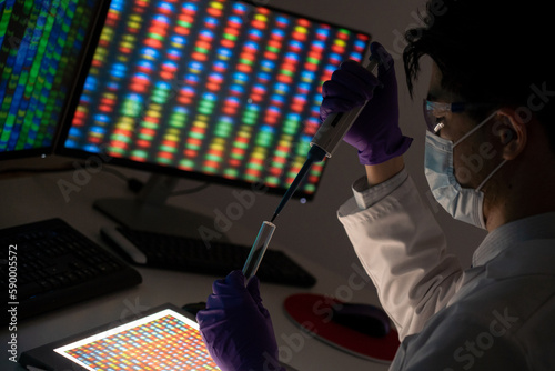 Male researcher in front of genome screens.