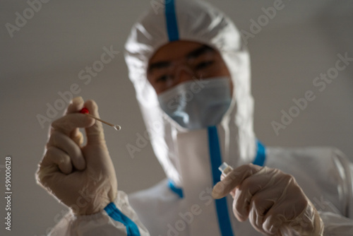 Medical personnel performing an antigen test for covid-19.