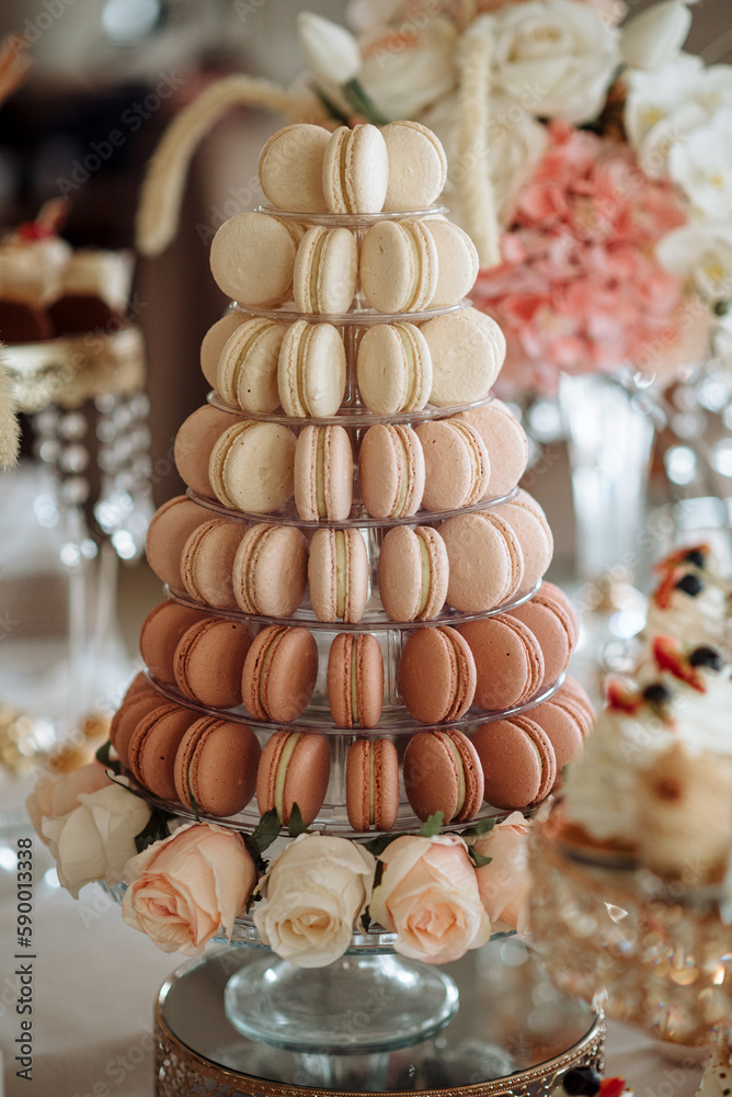 Pyramid of caramel and chocolate macarons at a wedding candy bar Pyramid of caramel and chocolate macarons at a wedding candy bar
