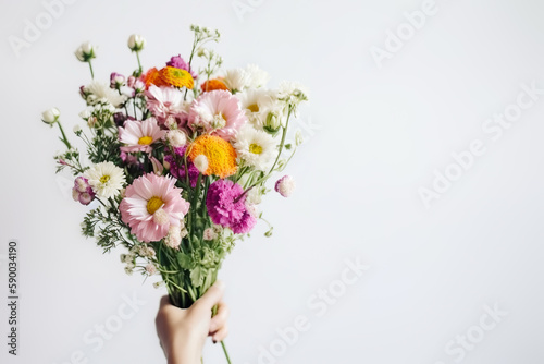 Slika na platnu Female hand holds beautiful bouquet of dahlias and chrysanthemums