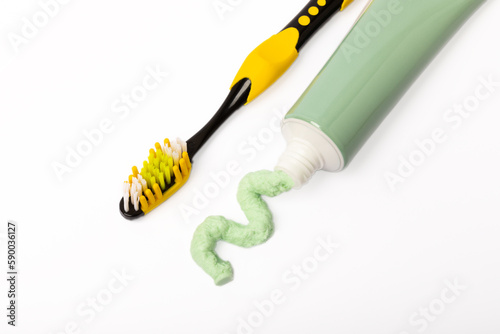 Tube of toothpaste and toothbrush isolated on white background. Close-up. Prevention of dental plaque and caries. Fresh breath. Dentistry concept. Oral care.