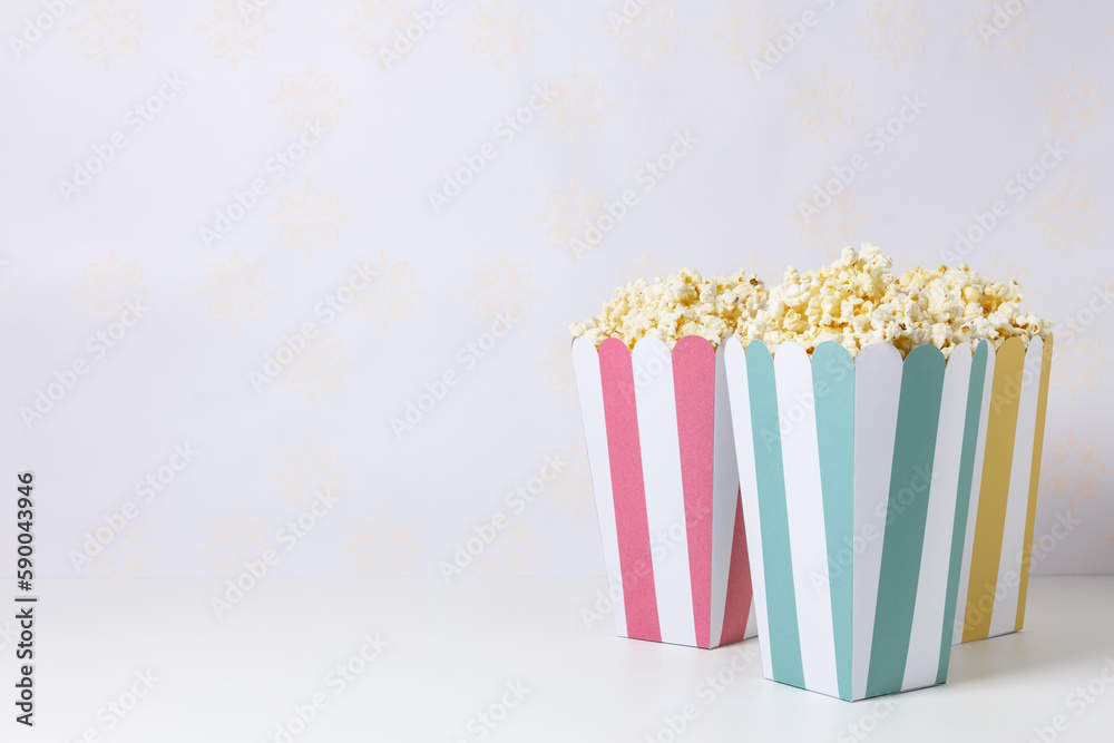 Popcorn inside bowls decorated with colorful stripes.