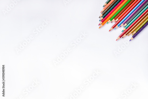 Composition with color pencils on white background, flat lay. Space for text