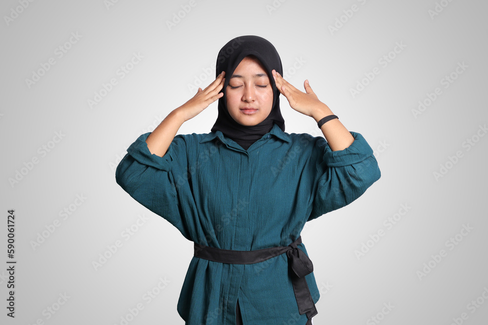 Portrait of excited Asian muslim woman with hijab showing thumb up hand gesture, saying good job. Advertising concept. Isolated image on white background