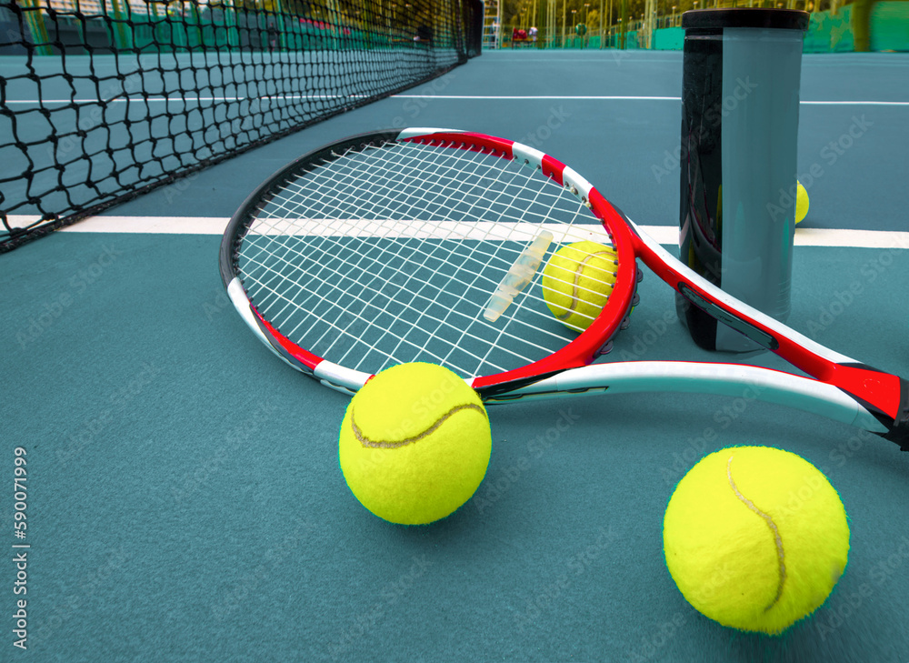 Tennis racket and ball on the blue-coated court