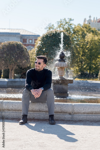 A boy sitting smiling, elegantly dressed