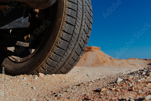 Car wheel on sand close-up view © chaossart