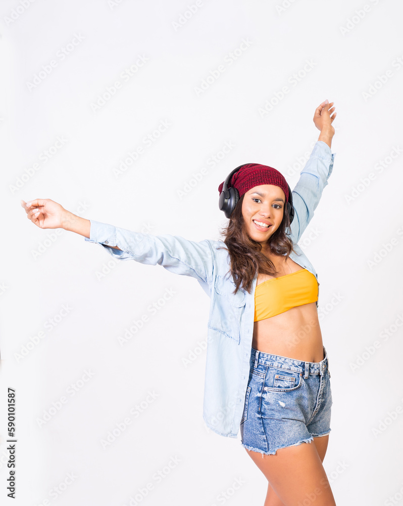 Mujer latina joven y bella escuchando musica con auriculares y ordenador portatil bailando alegre con una sonrisa Mujer latina joven y bella escuchando musica con auriculares y ordenador portatil bailando alegre con una sonrisa