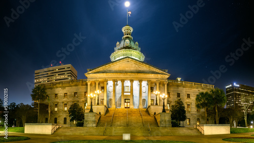 Illuminated South Carolina State House, in Columbia, SC, under a starry sky with a full moon. The South Carolina State House is the building housing the government of the U.S. state of South Carolina