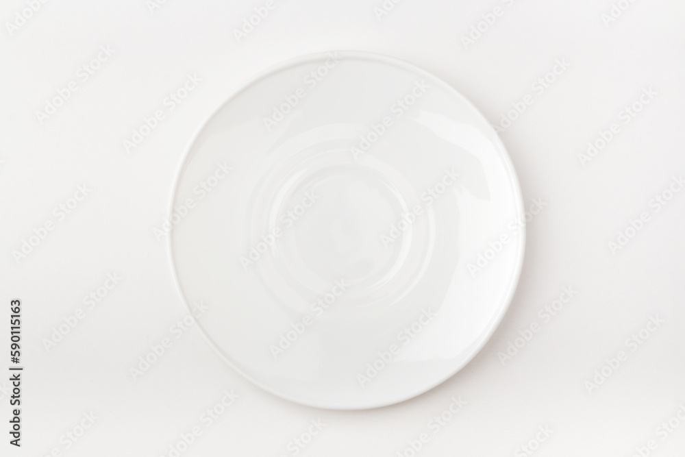 An empty white plate on a white background. Blank plate. Top view