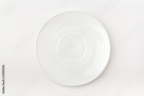 An empty white plate on a white background. Blank plate. Top view