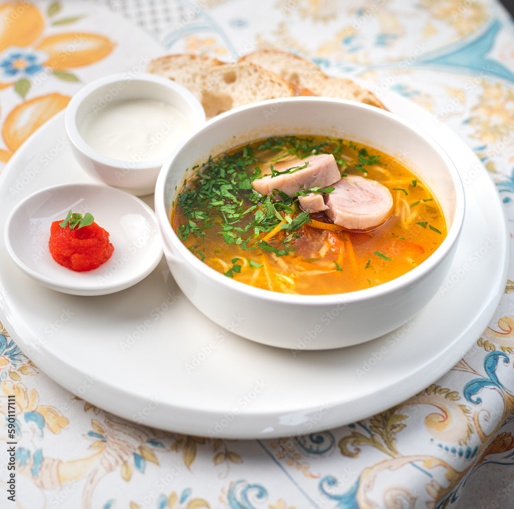 Chicken soup with noodles and vegetables in bowl. Healthy food concept Chicken soup with noodles and vegetables in bowl. Healthy food concept