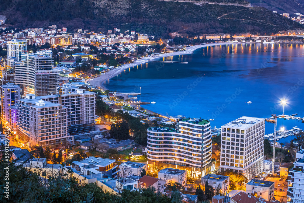 Naklejka premium Town of Budva beach and modern coastline architecture evening view