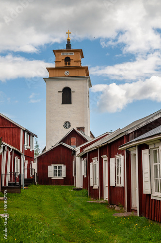 Gammelstad, Lulea, Sweden - street with small red historic wooden houses. A protected heritage village in the north of Europe. photo