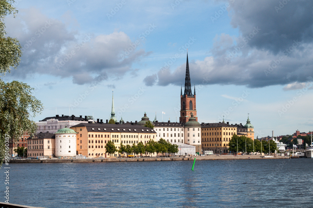 Stockholm, Sweden - Waterfront with buildings and historic part of Gamla Stan and church tower.
