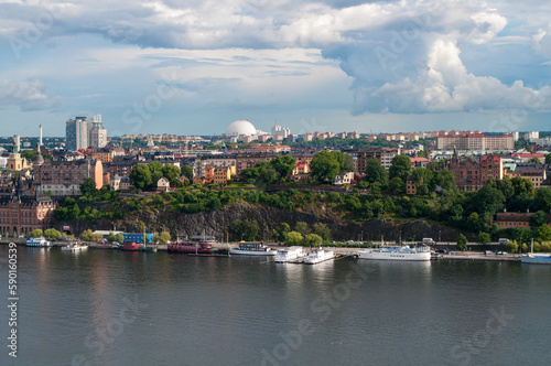 Stockholm, Sweden - Sea embankment with harbor and ships. The rock with trees and the city in the Globe Hall in the background. © Jan