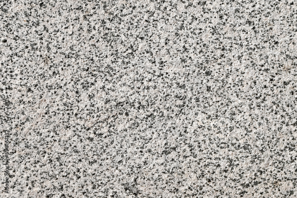 Closeup of a granite stone surface. White and black texture of a polished natural crystalline rock as a background Closeup of a granite stone surface. White and black texture of a polished natural crystalline rock as a background