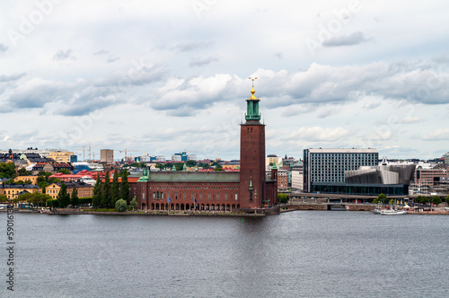 Photography Stockholm, Sweden - The embankment with the brick building of the town hall with an observation tower and modern houses in the vicinity