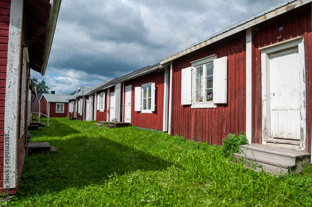 Gammelstad, Lulea, Sweden - street with small red historic wooden houses. A protected heritage village in the north of Europe. Gammelstad, Lulea, Sweden - street with small red historic wooden houses. A protected heritage village in the north of Europe.